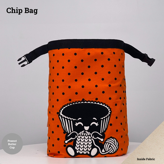 Orange-and-black polka dot Chip Bag featuring a peanut butter cup appliqué knitting beside a ball of yarn.
