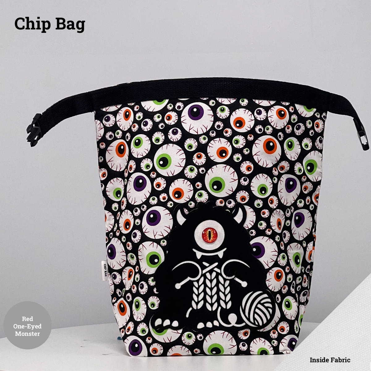 Eyeball-print Chip Bag featuring a black one-eyed monster with a red eye appliqué knitting beside a ball of yarn.