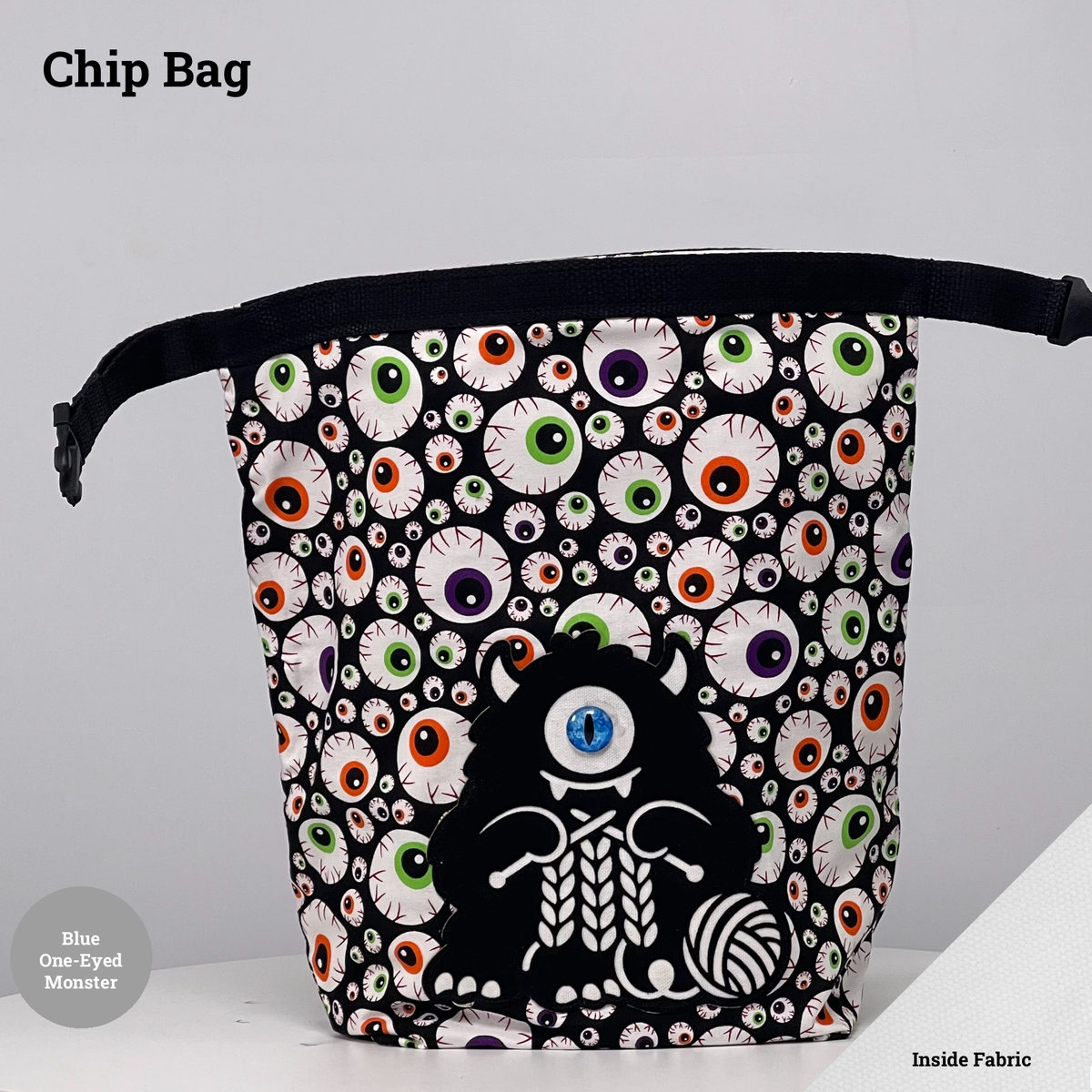 Eyeball-print Chip Bag featuring a black one-eyed monster with a blue eye appliqué knitting beside a ball of yarn.