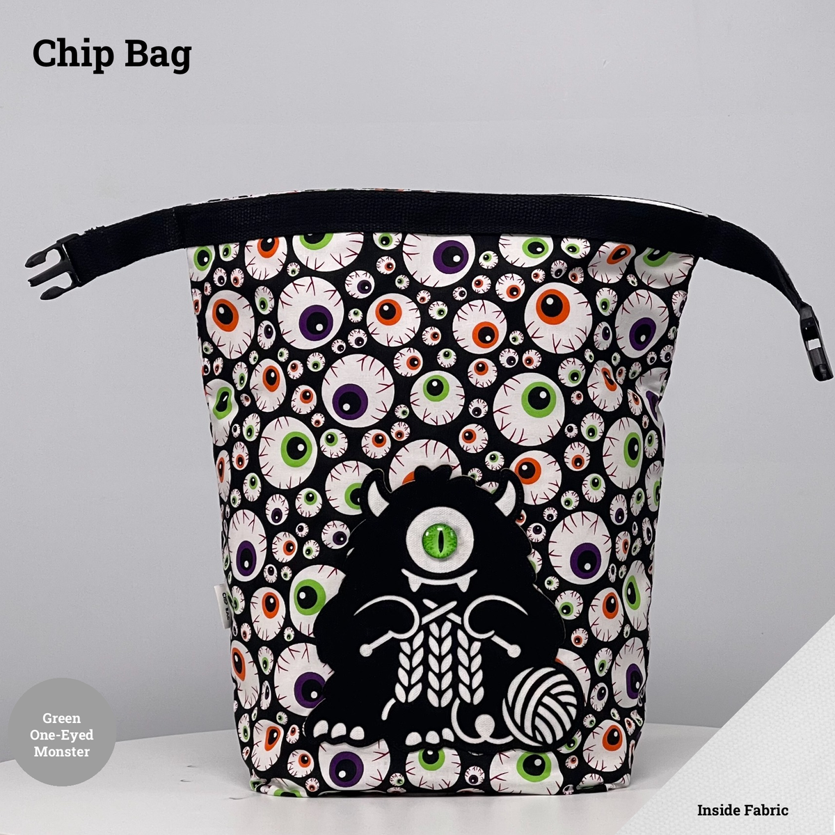 Eyeball-print Chip Bag featuring a black one-eyed monster with a green eye appliqué knitting beside a ball of yarn.