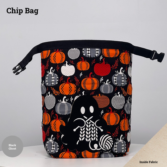 Black pumpkin-print Chip Bag featuring a black ghost appliqué knitting beside a ball of yarn.