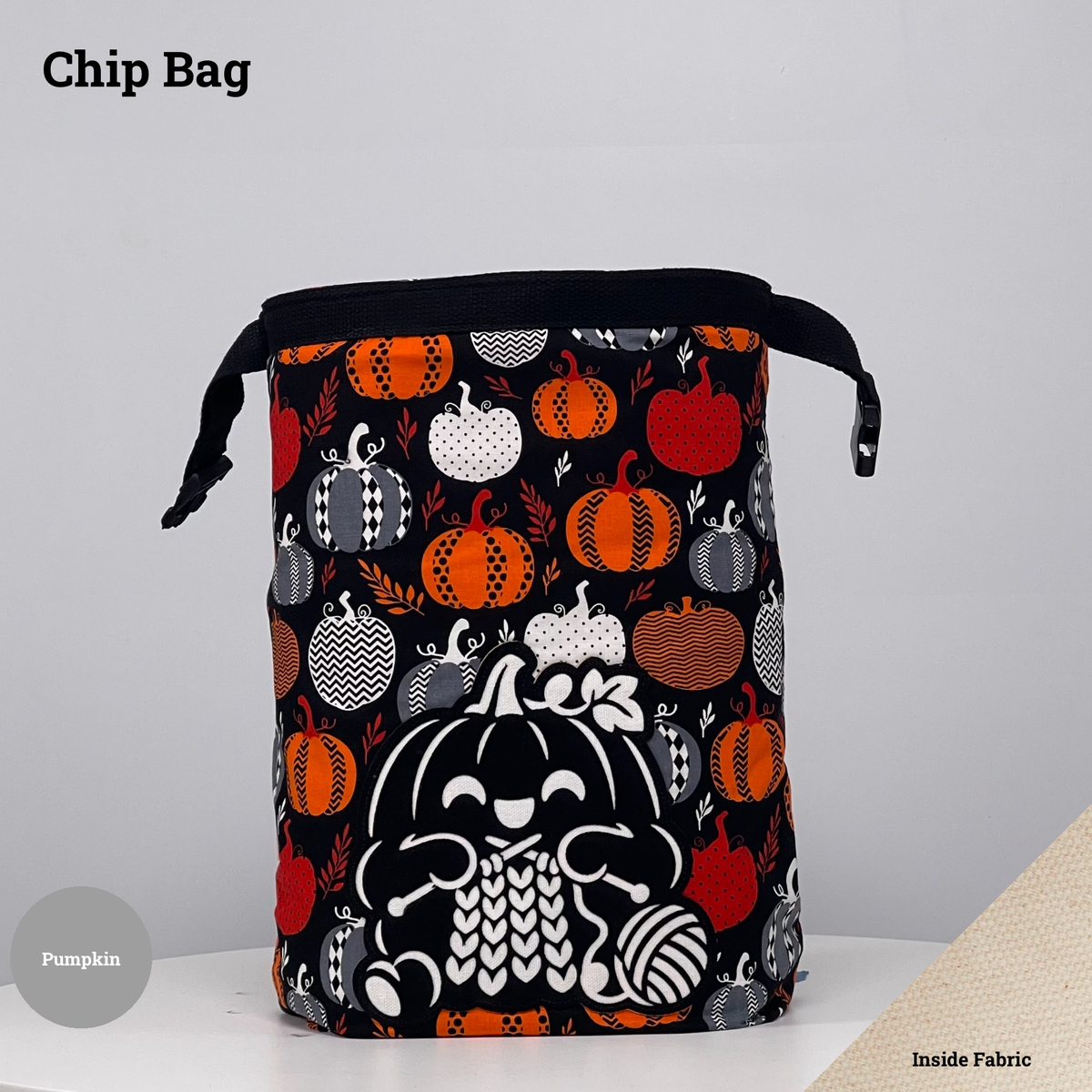 Black pumpkin-print Chip Bag featuring a pumpkin appliqué knitting beside a ball of yarn.